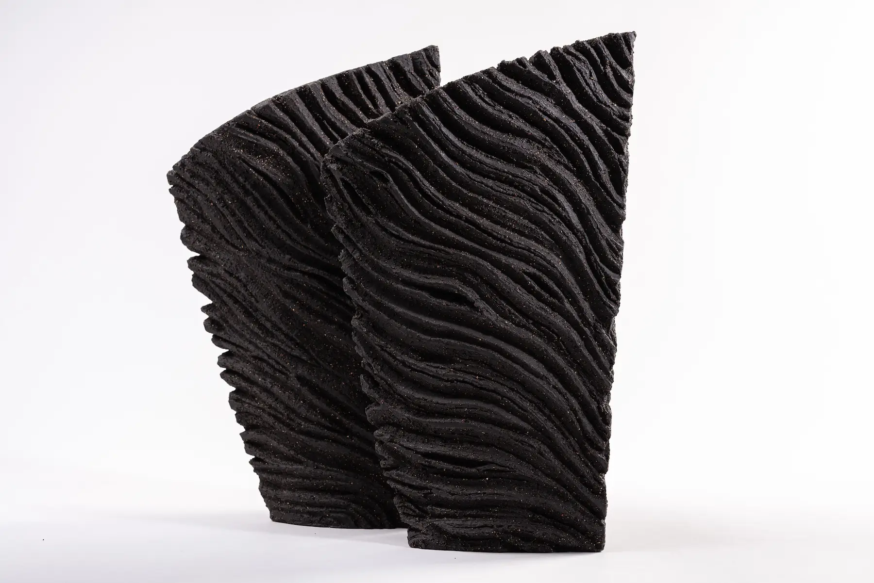 Together — Ribbons of Memory, a pair of carved hand-built black stoneware objects displayed together. Studio Willis.