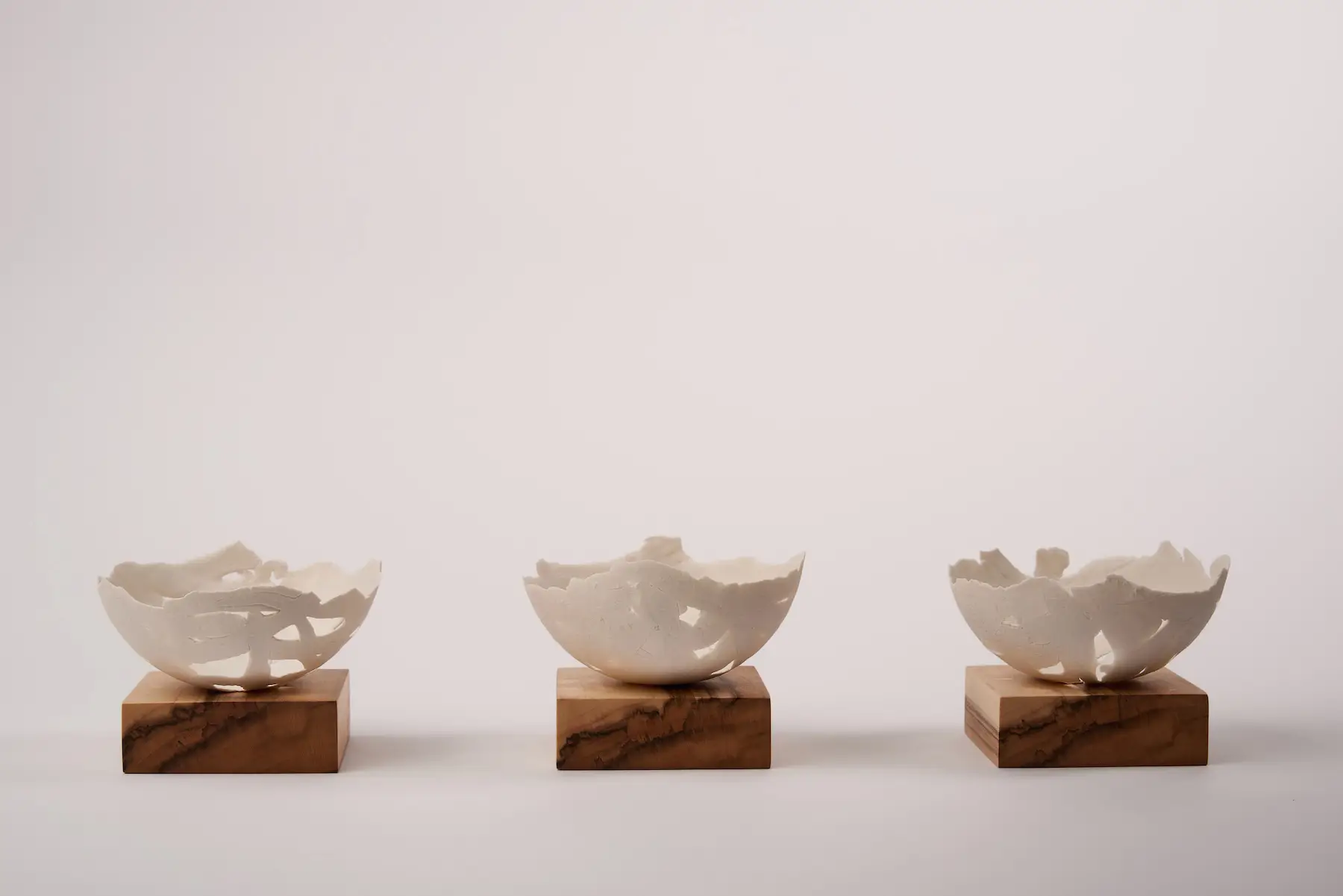 Scrap Paper, Spalted Maple — Screwed Up, three rough-textured hand-built porcelain bowls mounted on spalted maple wood. Studio Willis.