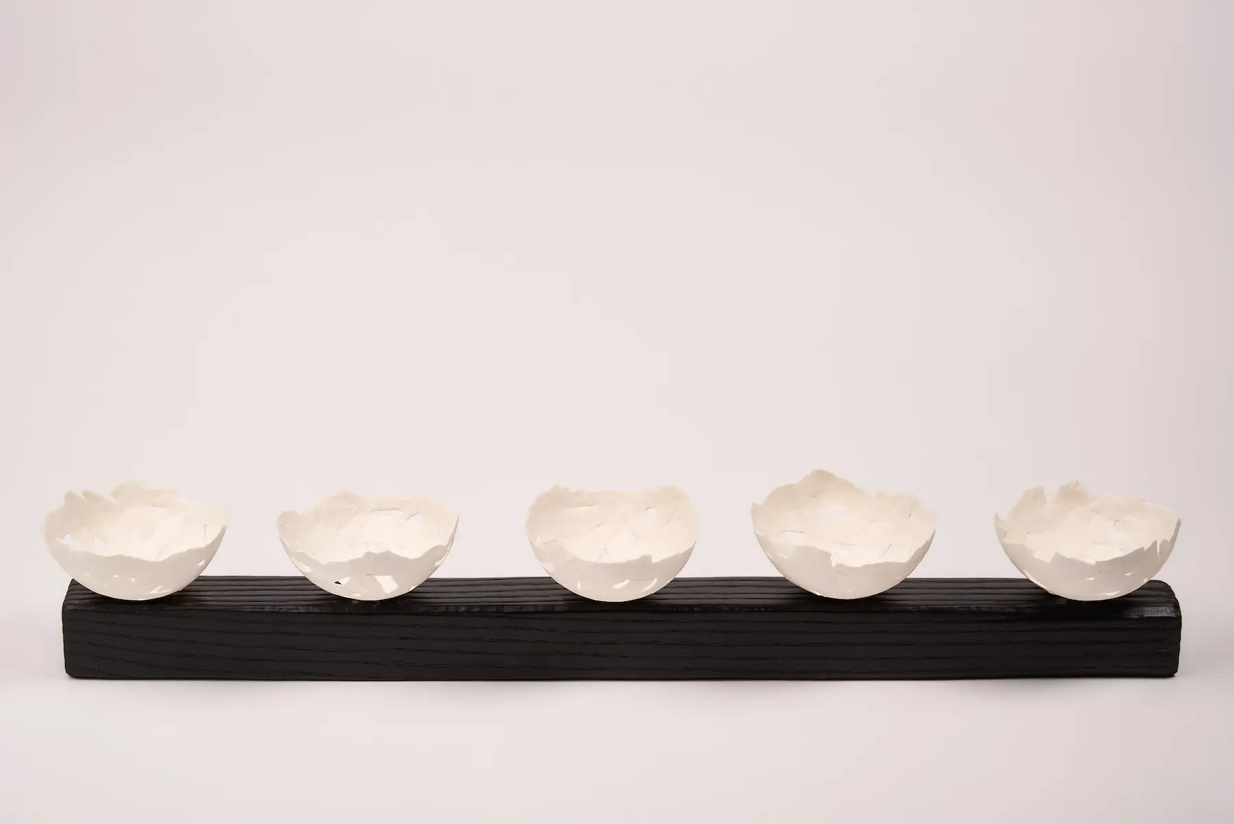 Scrap Paper, Vessels 5 — Screwed Up, five rough-textured hand-built porcelain bowls mounted on dark wood. Studio Willis.