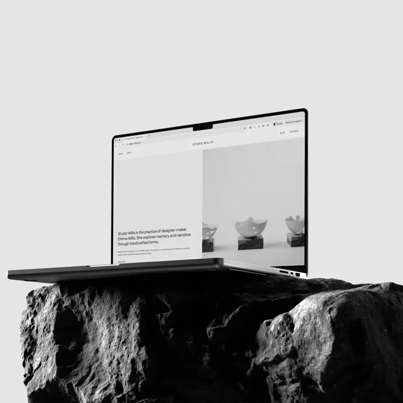 Studio Willis website displayed on a MacBook on stone.