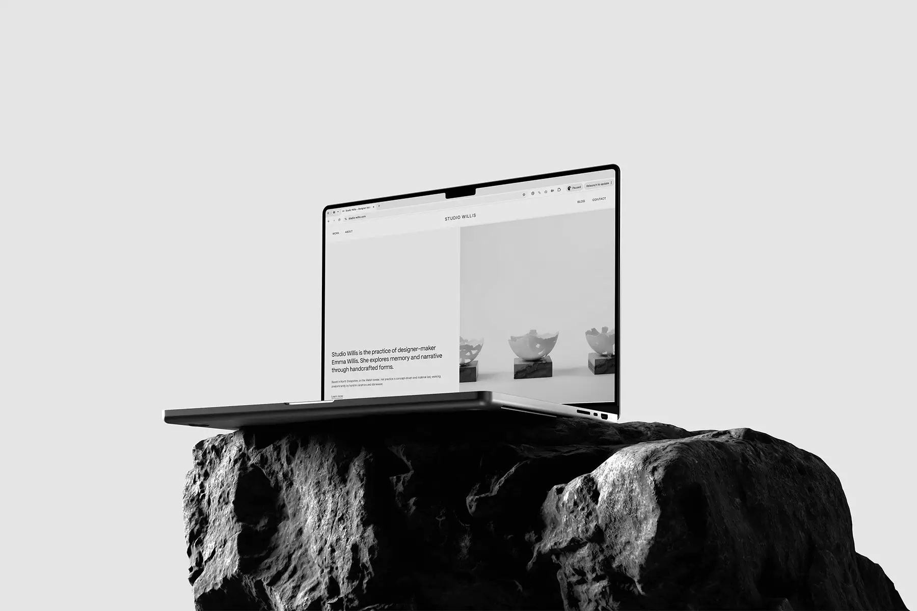 Studio Willis website displayed on a MacBook on stone.